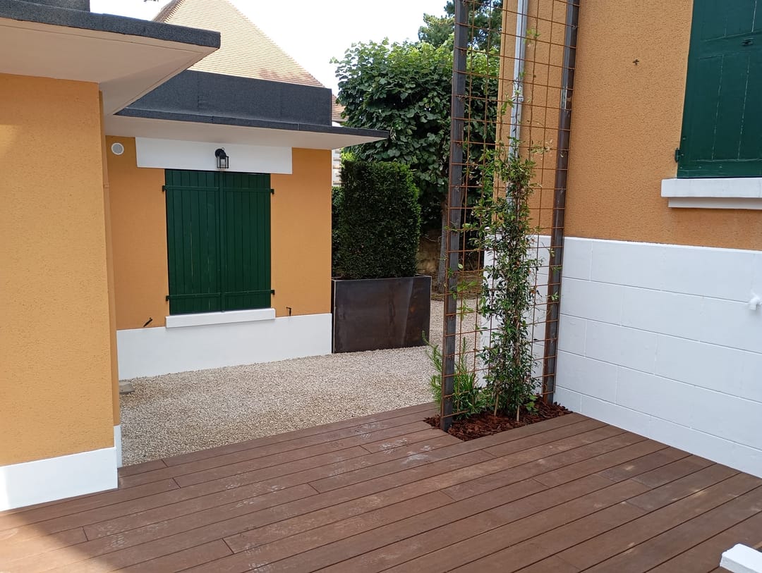 Terrasse en lames avec un treillage végétalisé